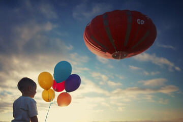 boy with balloons and a balloon with a basket in the sky. AI GENERATE