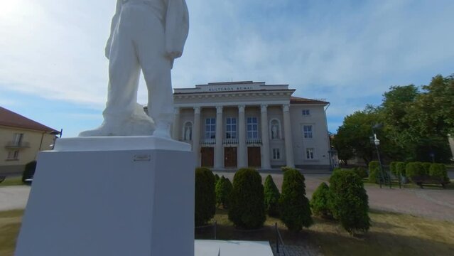 The Palace of Culture and the sculpture of a worker in Naujoji Akmene, Lithuania. Slow Motion Footage
