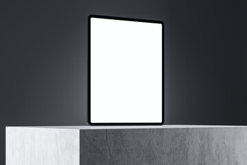 Close up of empty white tablet screen on concrete surface and gray wall background. Product presentation and advertisement concept. Mock up, 3D Rendering.