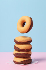 Chocolate donuts on paper on blue background