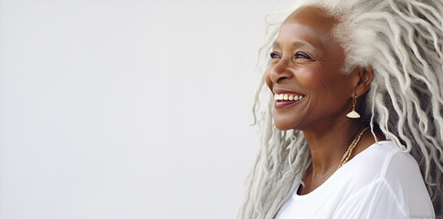  portrait of a beautiful elderly  black woman with long white hair, dressed white and light white background, posing and looking on camera
