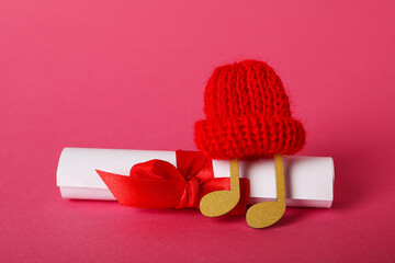 Note in a warm hat on a pink background.