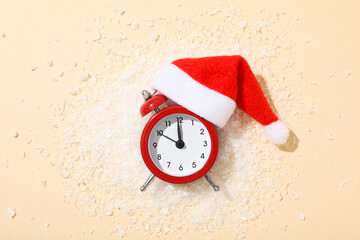 A clock with a Santa hat with a New Year's decoration.
