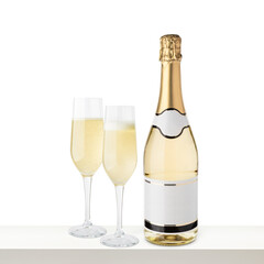 Champagne bottle with blank label and glasses on white shelf.