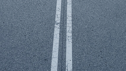 an asphalt road. close-up of a traffic road. white line on a road. cracked paint line of a road. - obrazy, fototapety, plakaty