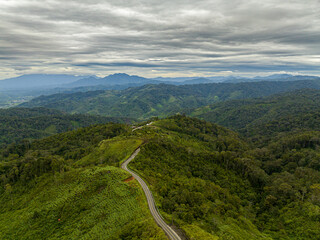 Aerial view of mountains and hills with green forest and trees in the tropics. Sumatra, Indonesia.