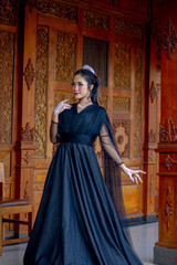 Obraz premium Women's fashion model. Female makeup model. Asian woman. Indonesian women. wearing a black wedding dress. Black wedding dress.