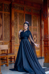 Obraz premium Women's fashion model. Female makeup model. Asian woman. Indonesian women. wearing a black wedding dress. Black wedding dress.