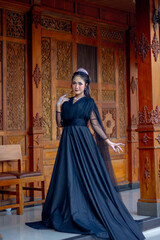 Obraz premium Women's fashion model. Female makeup model. Asian woman. Indonesian women. wearing a black wedding dress. Black wedding dress.