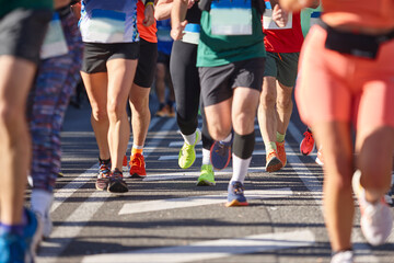 Fototapeta na wymiar Runners on the street. Healthy lifestyle. Marathon. Athletics. Front view