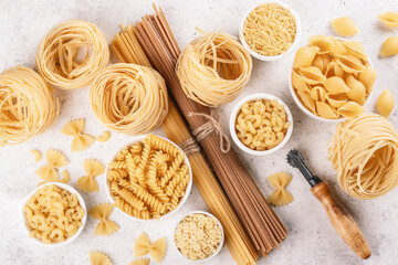 Pasta month. Assortment of uncooked pasta and noodles. Italian food culinary concept. Collection of different raw pasta on cooking table