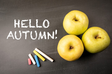 Hello Autumn! Green apples on a dark chalkboard backgroun