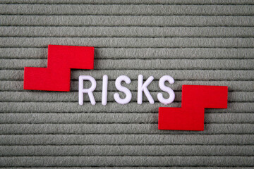 Obraz premium RISKS Concept. White letters of the alphabet on a green background
