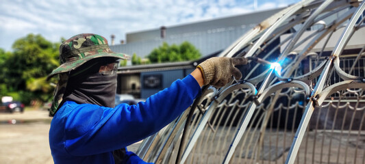 Technician using welding equipment for wrought iron work