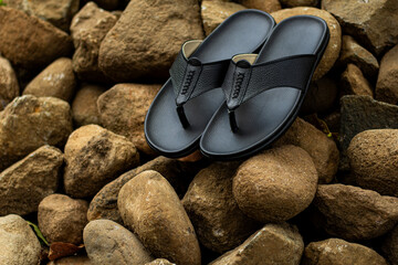 Black leather sandals, pictured outdoors. outdoor leather sandals. leather sandals