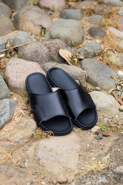 Black leather sandals, pictured outdoors. outdoor leather sandals. leather sandals