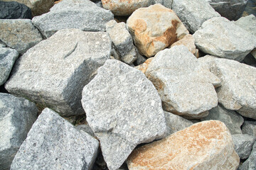 Close up of a pile of large crushed granite stones, to sell as building material and Waterproof line