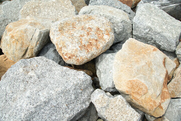 Close up of a pile of large crushed granite stones, to sell as building material and Waterproof line