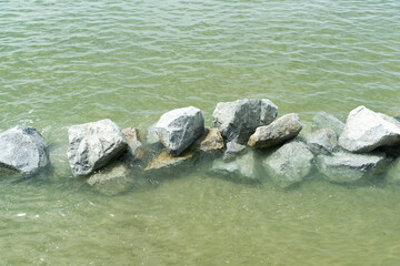 Close up of a pile of large crushed granite stones, to sell as building material and Waterproof line