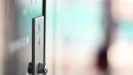 inserting a coin into a coin machine using 100 Japanese Yen coins