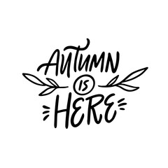 Autumn is here hand written lettering phrase.