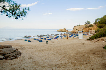 Fototapeta na wymiar Peaceful coastal scene with clear sky, sandy beach, and calm seascape at morning.