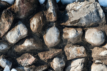 texture of cobblestone stones in a concrete old wall