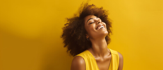 Beauty portrait of African American girl with afro hair. Beautiful black woman on a yellow isolated background. Cosmetics, makeup and fashion - obrazy, fototapety, plakaty