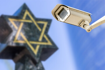 Security camera with star of David on background. concept of monitoring religious buildings of the Jewish faith