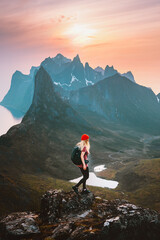 Traveler woman hiking alone in mountains outdoor travel summer vacations healthy lifestyle active girl with backpack on trail in Norway explore Senja island