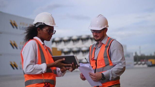 Engineers railway team wearing safety uniform under conversation document on hand inspection survey container boxes railway work station is industry transportation cargo import export concept.