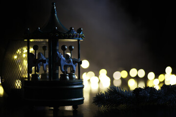 light carousel at night with horses in winter Carousel fun time Christmas night time