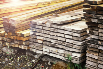 Stack of fresh pine boards in a sawmill warehouse. Harvesting, sale of lumber for construction