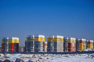 new residential area with new buildings under a blue sky in winter