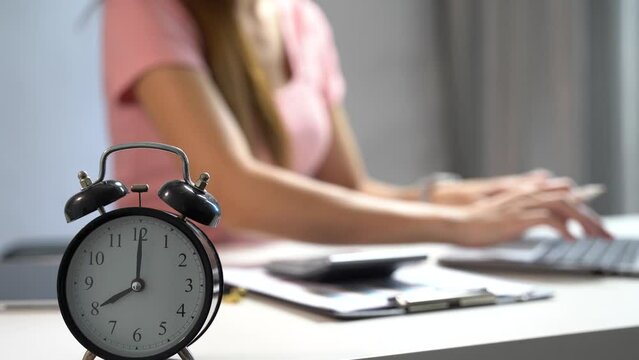Woman sit at workplace desk in home office use calculator calculates monthly expenses, taxes.