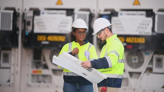 Engineers railway team wearing safety uniform under conversation document on hand inspection survey container boxes railway work station is industry transportation cargo import export concept.