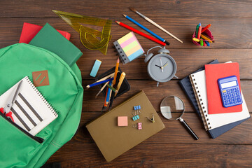 Back to school - books and school backpack on the desk in the auditorium, Education concept.