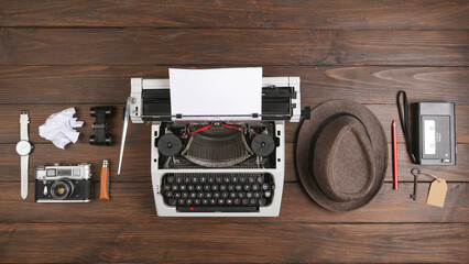 Journalist or private detective workplace - typewriter, camera, hat, recorder and other stuff, flat view above
