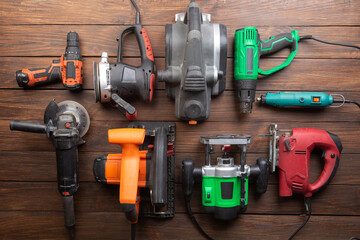 Set of electric tools on the wooden table. Various power tools for renovation and construction