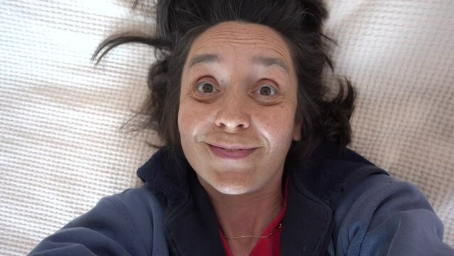 Fethiye, Turkey - 17th of May 2023: 4K Tired single mother 50 years old making her selfie and trying to smile
