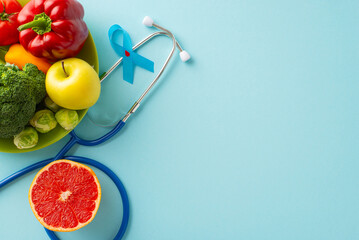 Diabetes-Friendly Meal Plan: Top view photo of diabetes emblem, stethoscope, and a plate of nutritious fruits and vegetables on a pastel blue background. Ideal for diabetes diet ideas