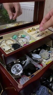 woman hands take knick-knackery rings earrings neckless