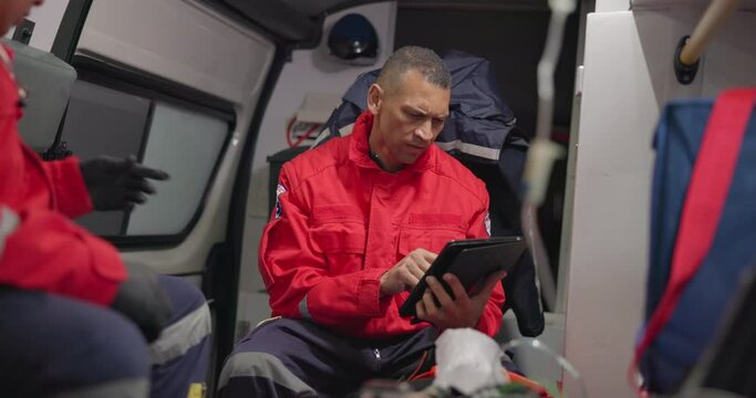 Ambulance, patient and paramedic with tablet for healthcare with technology, communication and doctor update. Ems, accident and victim with oxygen mask, digital medical service and transportation