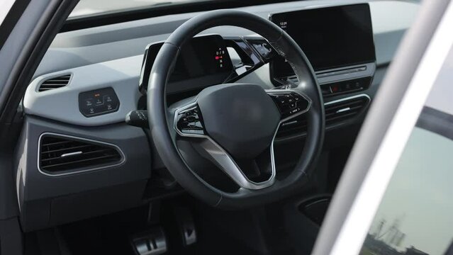 Interior of prestige modern car. Leather comfortable seats, dashboard and steering wheel. Cockpit with exclusive decoration. Modern electric car interior luxury