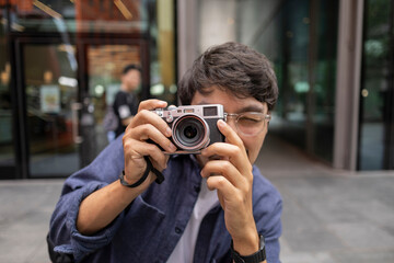 tourist man takes photos with a camera in the city of london