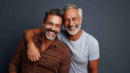 Fototapeta premium Gay male couple happy with a neutral background and copyspace