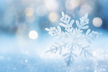 Fototapeta na wymiar Beautiful delicate snowflake on snowy sparkling blue background