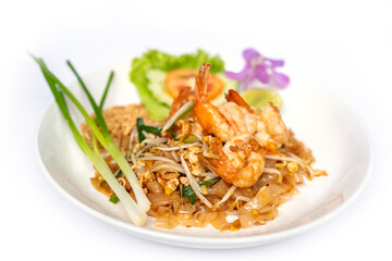 Thai noodle stir fry with a sweet-savoury-sour sauce scattered with crushed peanuts on top with prawn.
