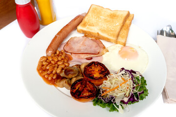 Full English Breakfast With Pork Sausage with grilled tomatoes and Stewed Beans.