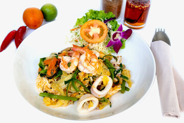 Stir fried vermicelli with seafood on white isolated.